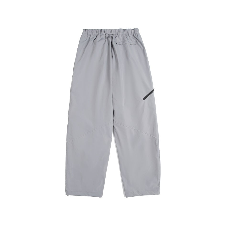 Back view of light gray pants with an elastic waistband, a rear pocket, and a small black accent.
