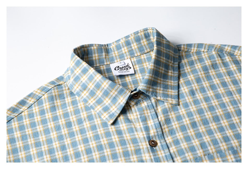 Close-up of the shirt collar, buttons, plaid pattern, and sewn-in English brand label.