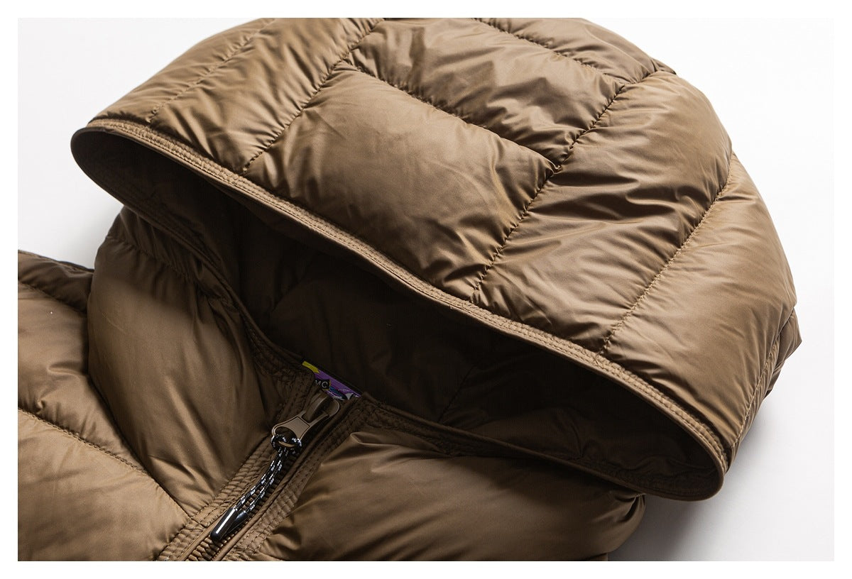 Close-up of the brown puffer jacket's hood and front zipper with a small interior label visible.