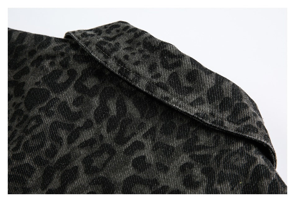 Close-up of a pointed collar and dark leopard print on a charcoal garment.