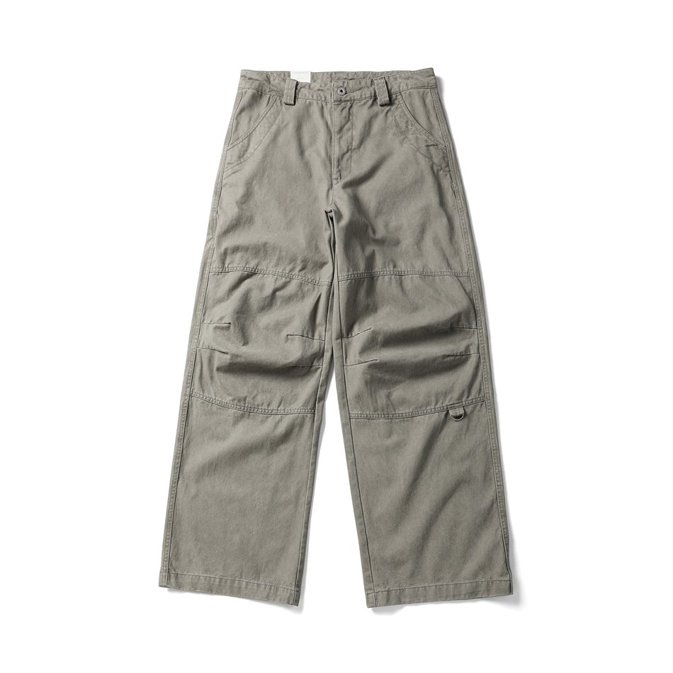 Front view of light khaki wide-leg work pants with knee panel seams, slanted pockets and a D-ring detail