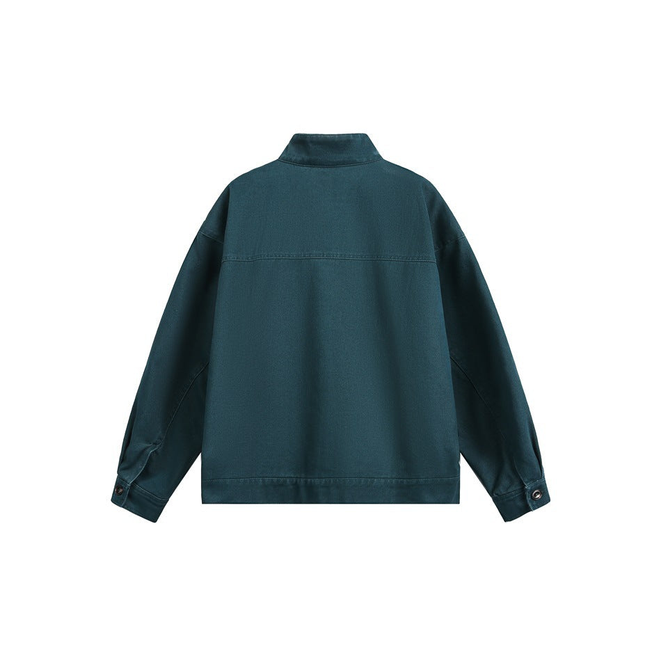Back view of a dark teal jacket with a high collar, dropped shoulders, and buttoned cuffs.