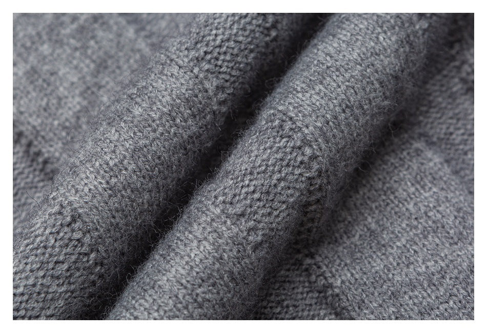 Extreme close-up of gray knit fabric folds showing the stitch texture.