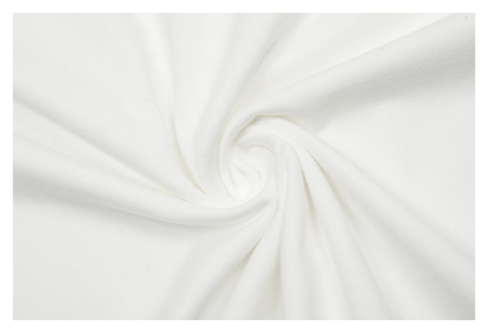 Close-up of white fabric gathered into a swirl, showing its surface and drape.