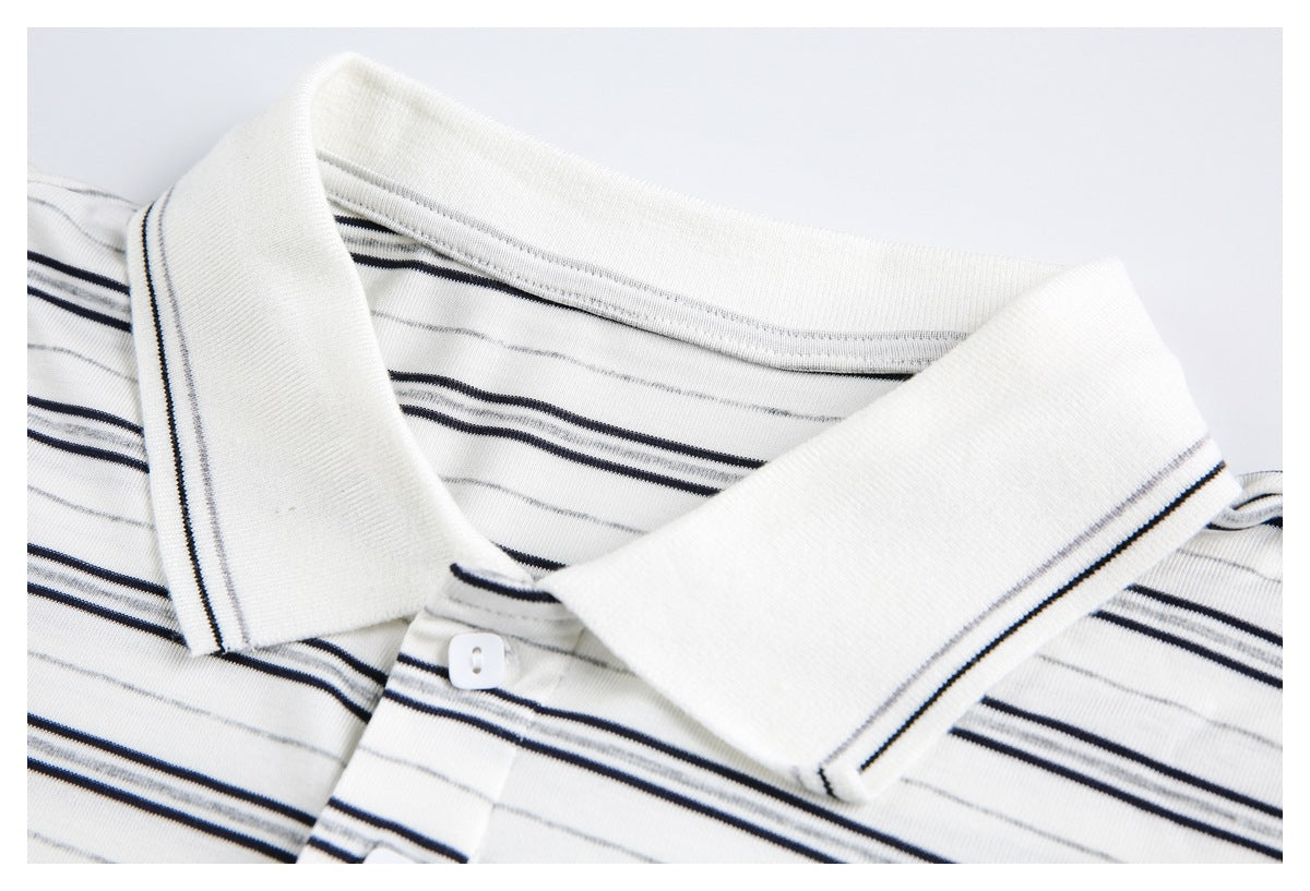Close-up of a white polo shirt collar with thin black and gray stripes and a buttoned placket.