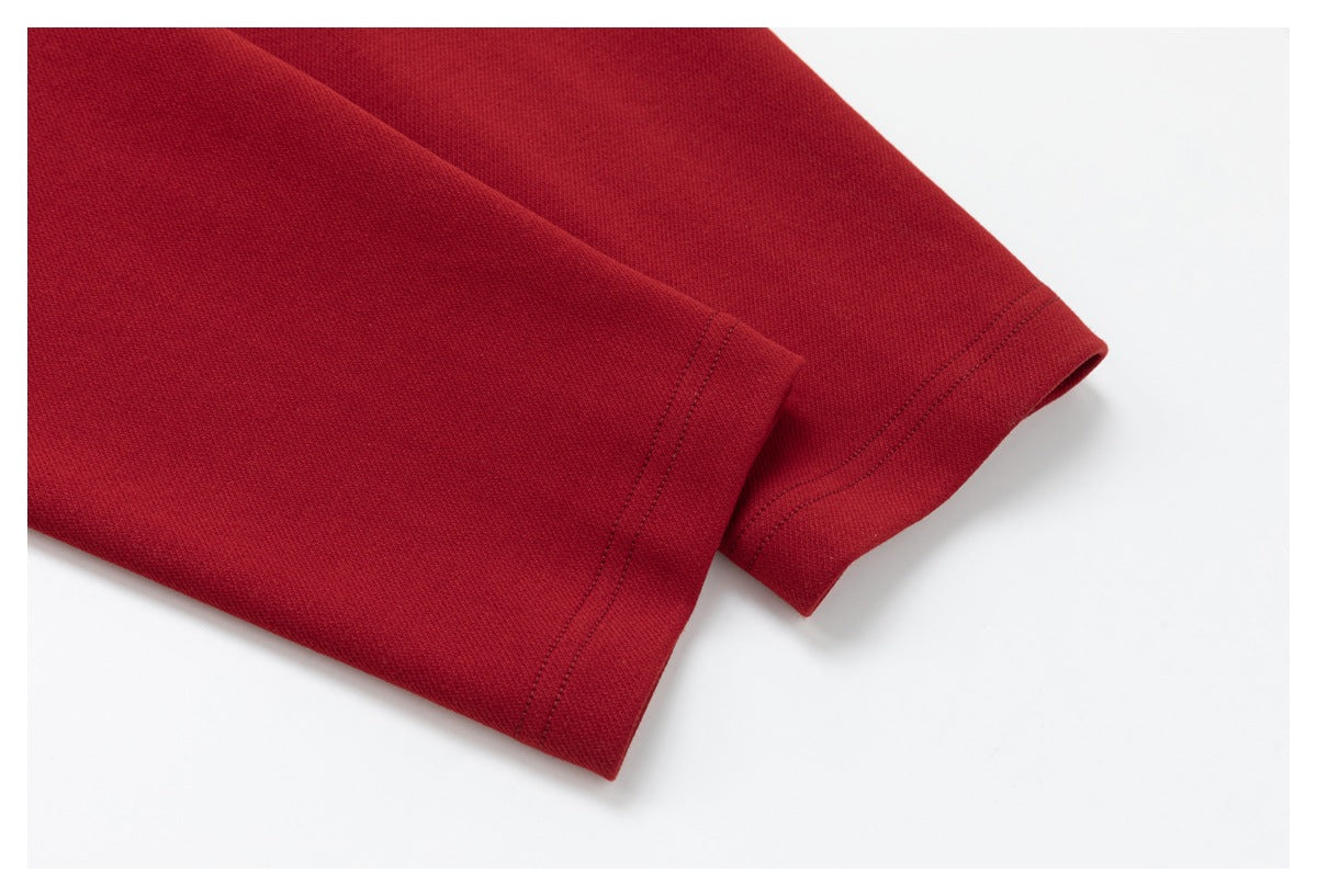 Close-up of two plain red sleeve cuffs with visible double-stitched hems.