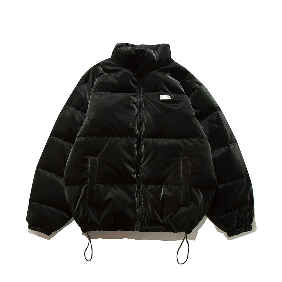Black quilted puffer jacket with stand collar, front zipper, slanted pockets and drawcord hem, shown flat