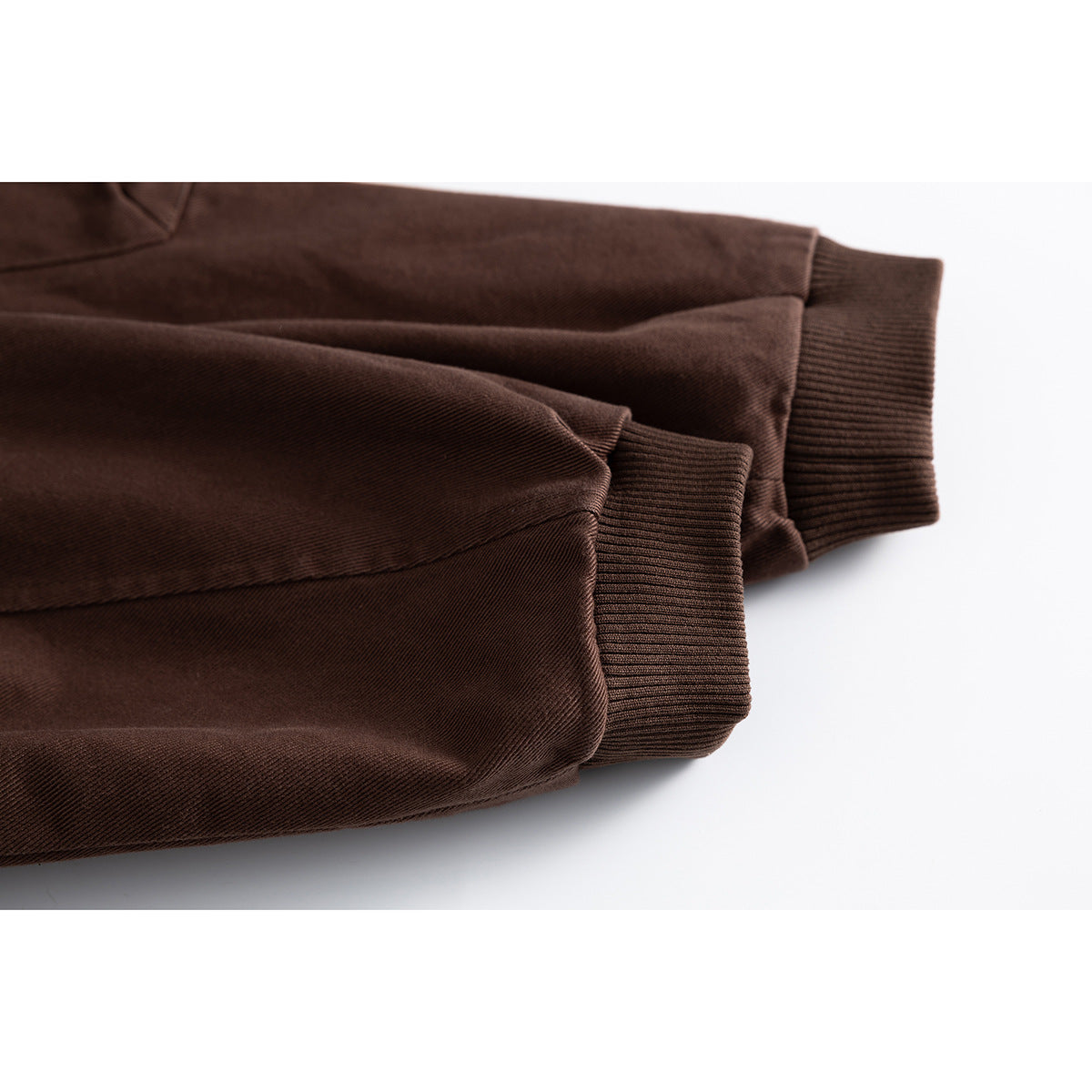 Close-up of the brown jacket’s sleeves and ribbed cuffs.