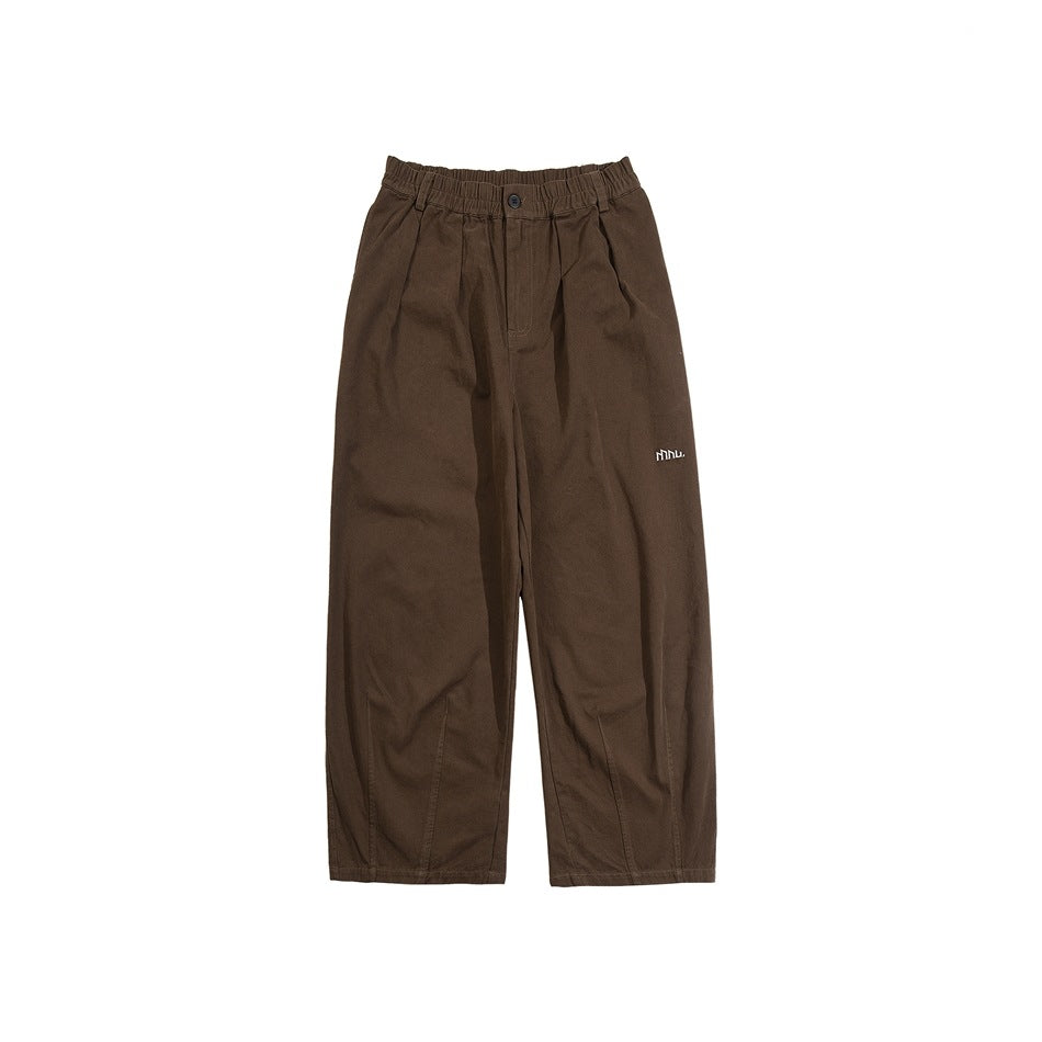 Coffee brown wide-leg pants with elastic waistband, front pleats and small embroidered logo, flat lay on white