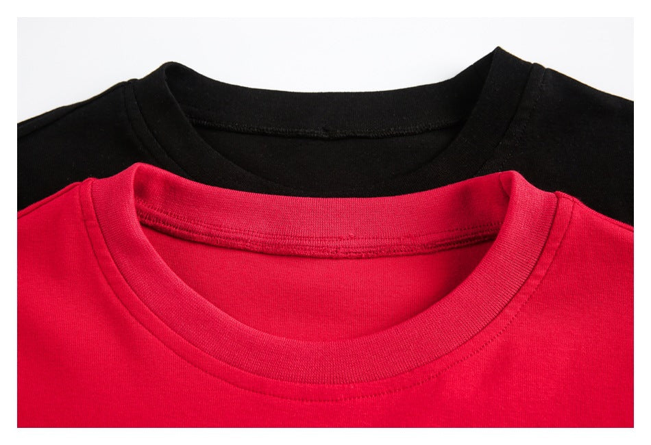 Close-up of the crew necklines and stitching on black and red T-shirts.