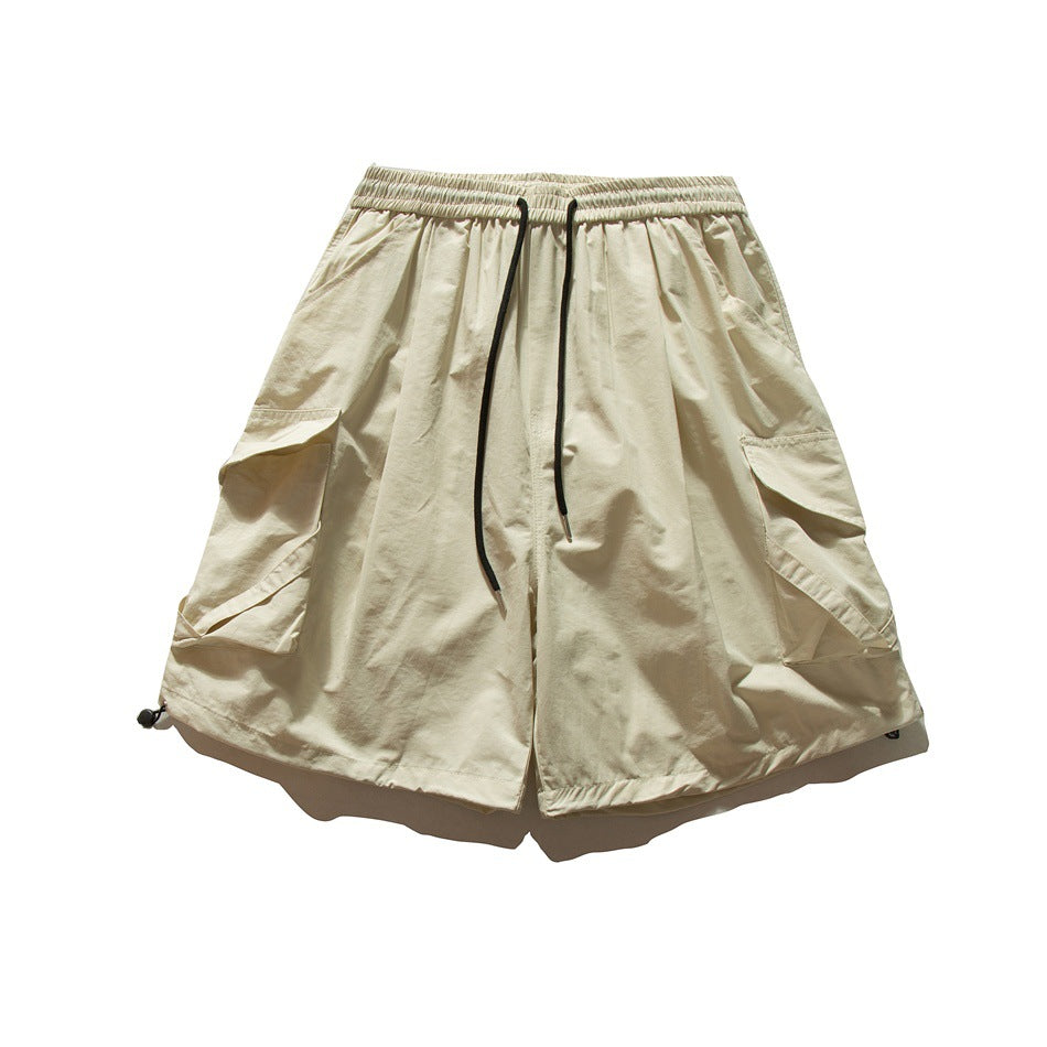 Beige cargo shorts front view with elastic drawstring waist and large side flap pockets