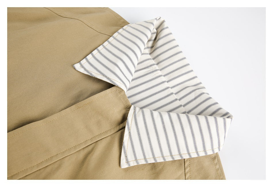 Close-up of a tan garment with a cream lining patterned in thin dark stripes.
