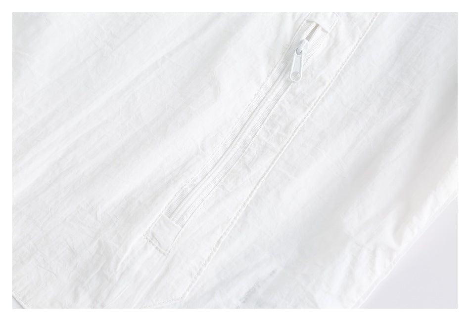 Close-up of a white zipper set into crinkled white fabric.
