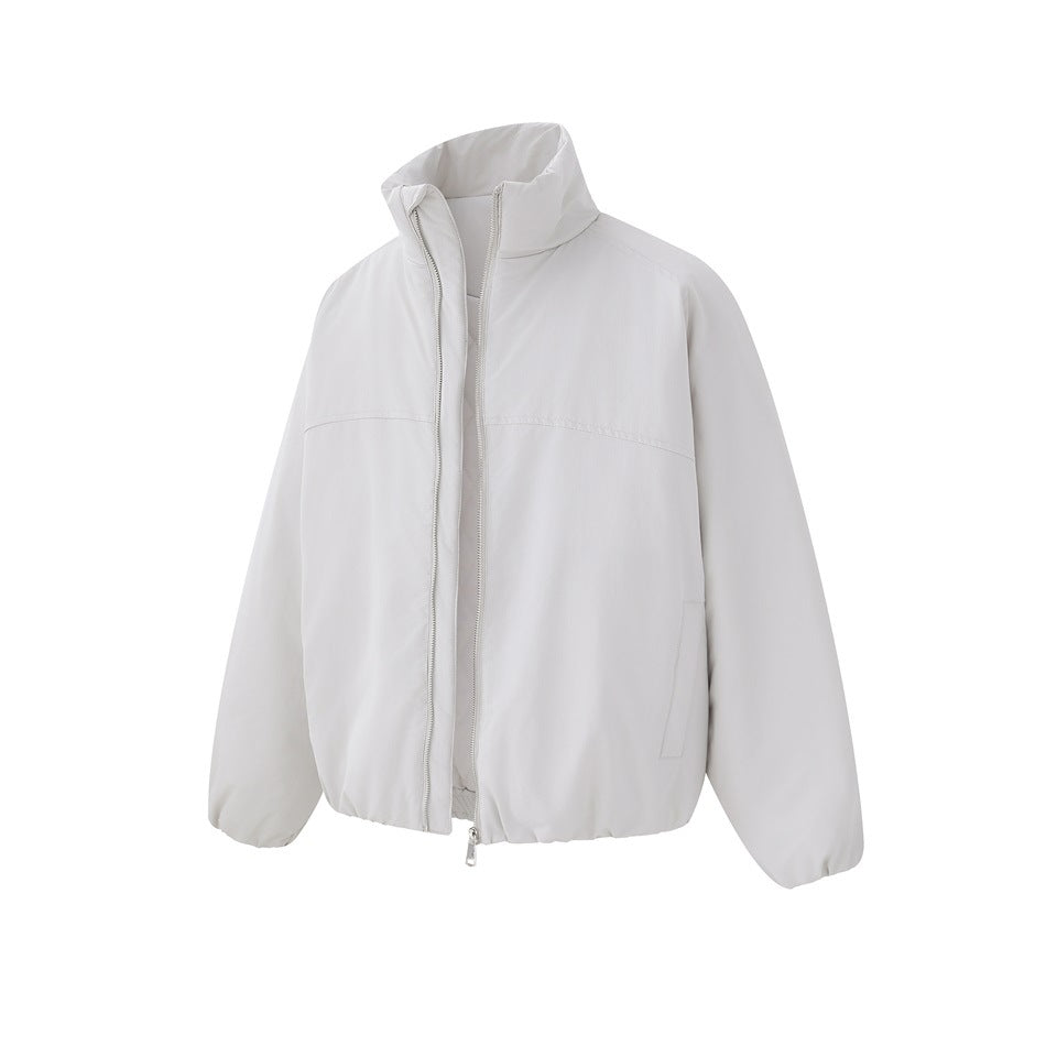 Light gray padded stand-collar zip jacket with silver zipper, open slightly, seen from a three-quarter front angle