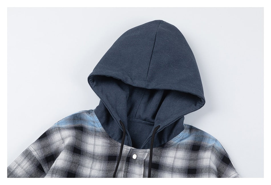 Close-up of a dark blue hood and drawstrings above the blue, black and white plaid front of the overshirt.