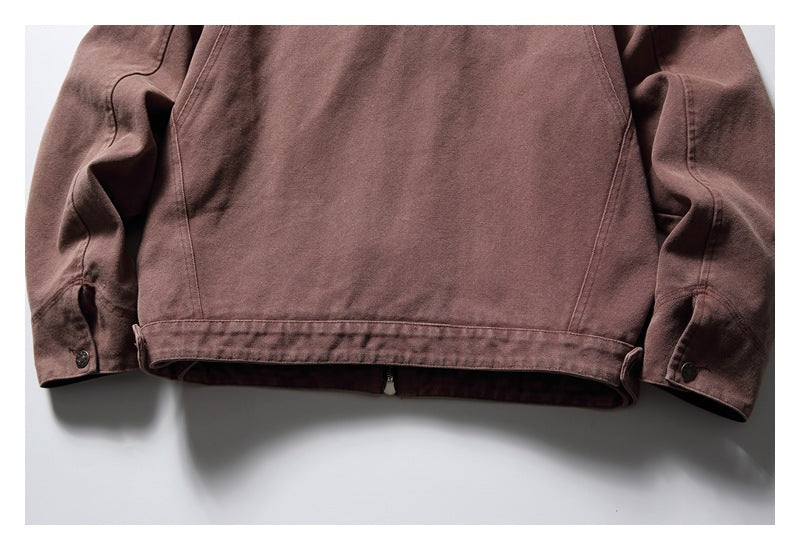 Cropped view of the lower back and sleeves of a muted brown jacket, showing the hem and sleeve cuffs.