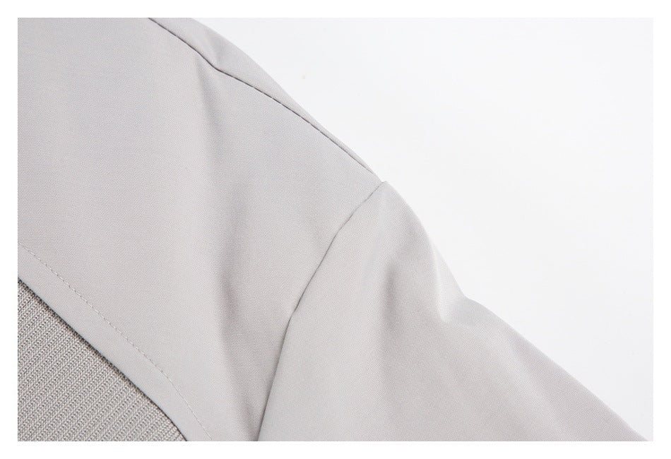 Close-up of the light gray jacket's shoulder seam and sleeve.