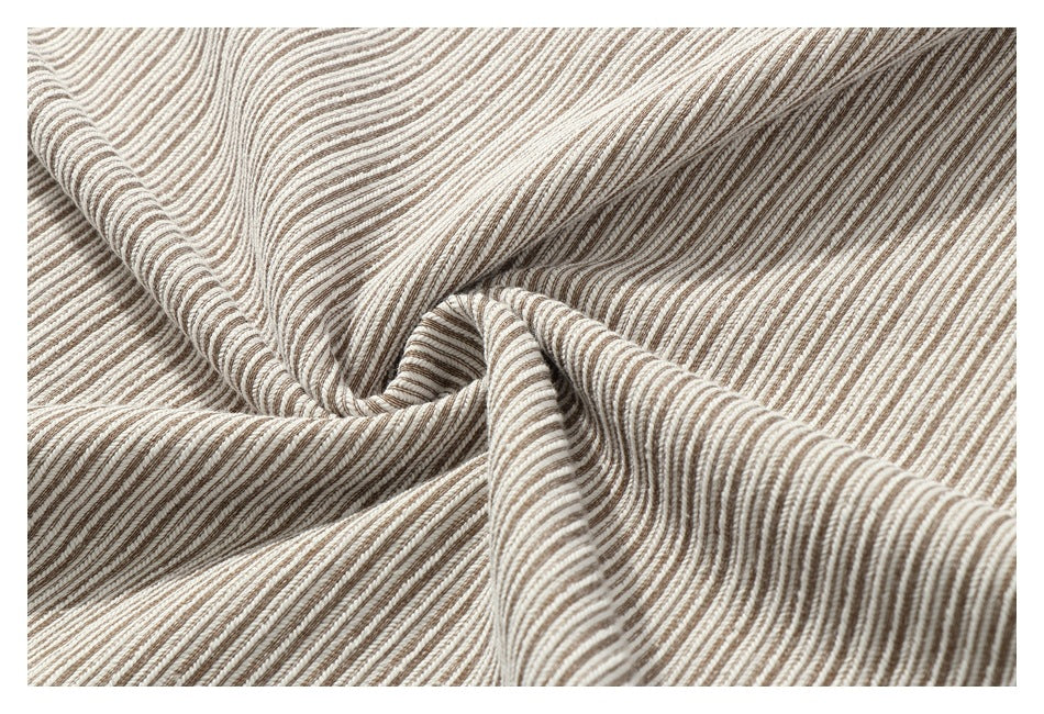 Close-up of striped fabric gathered into folds, showing its textured surface.