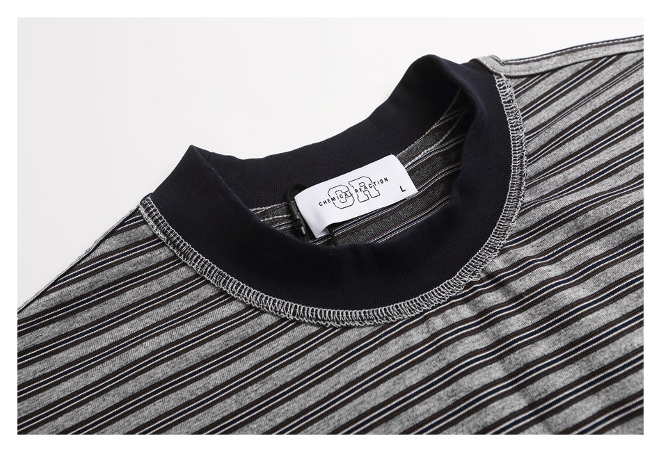 Close-up of the T-shirt's dark ribbed crew neck, striped fabric, stitching, and sewn-in size label.