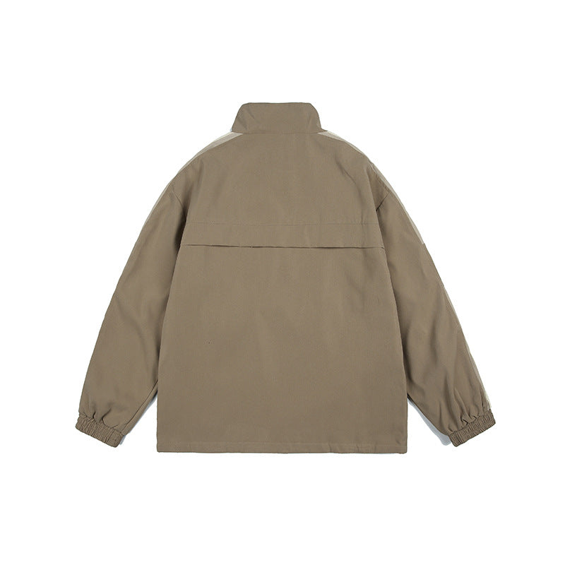 Back view of a taupe pullover jacket with a high collar, shoulder yoke, and elastic cuffs on a white background.