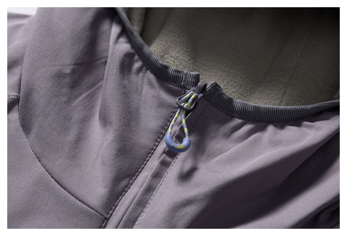 Close-up of the purple jacket hood opening, lining, and patterned drawcord toggle.
