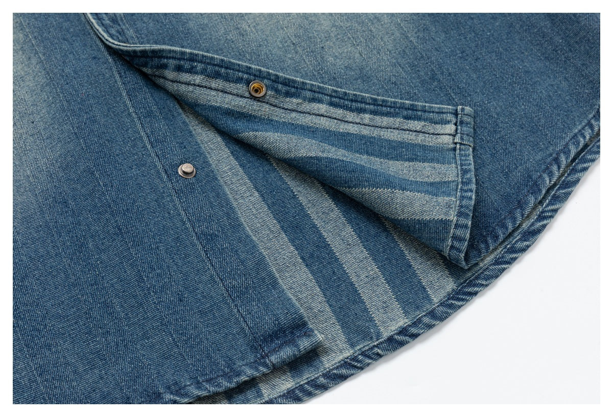 Close-up of an opened snap-button fastening on blue denim, showing the inner fabric and metal snap parts.