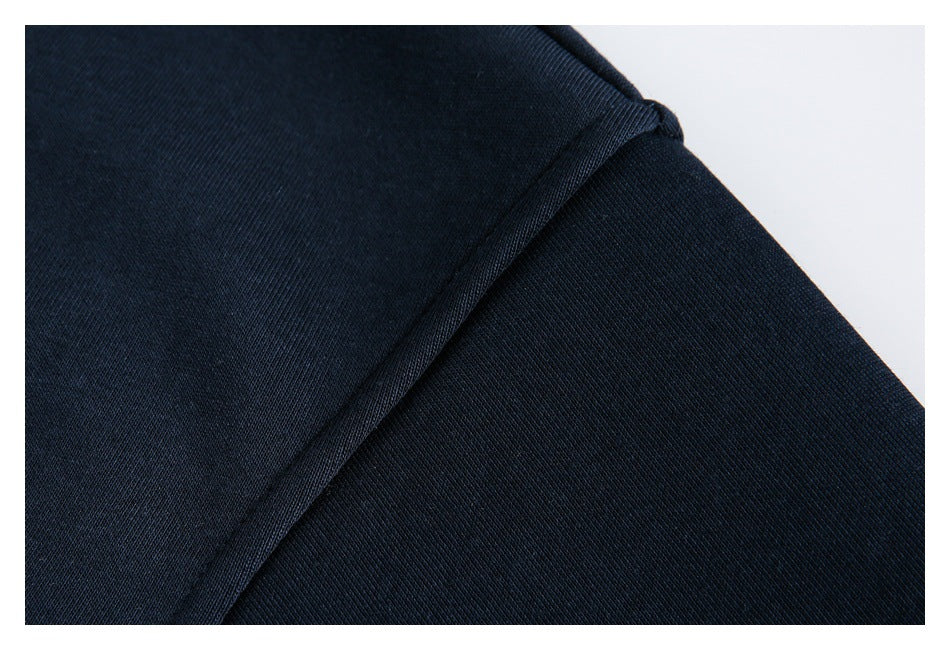 Close-up of a stitched seam on dark navy fabric.