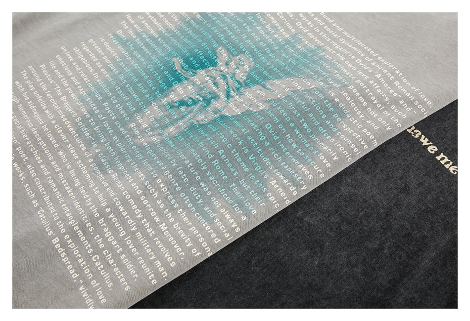 Close-up of white text printed across light gray and charcoal washed T-shirt fabric.