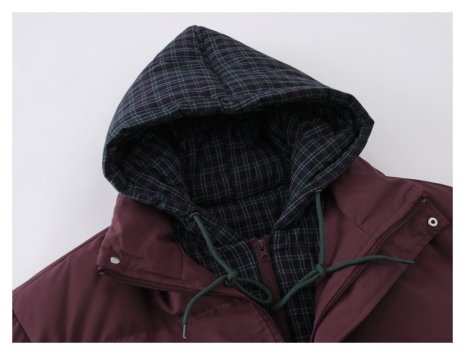 Close-up of a burgundy jacket hood with dark plaid lining and drawstrings.