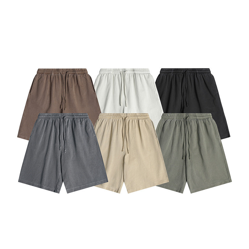 Six pairs of loose shorts shown from the front in brown, white, black, gray, beige, and muted green.