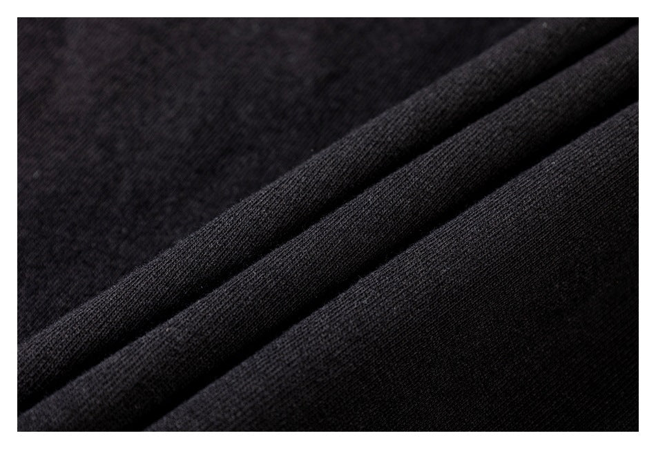 Macro view of the black garment's knit fabric and folded material.