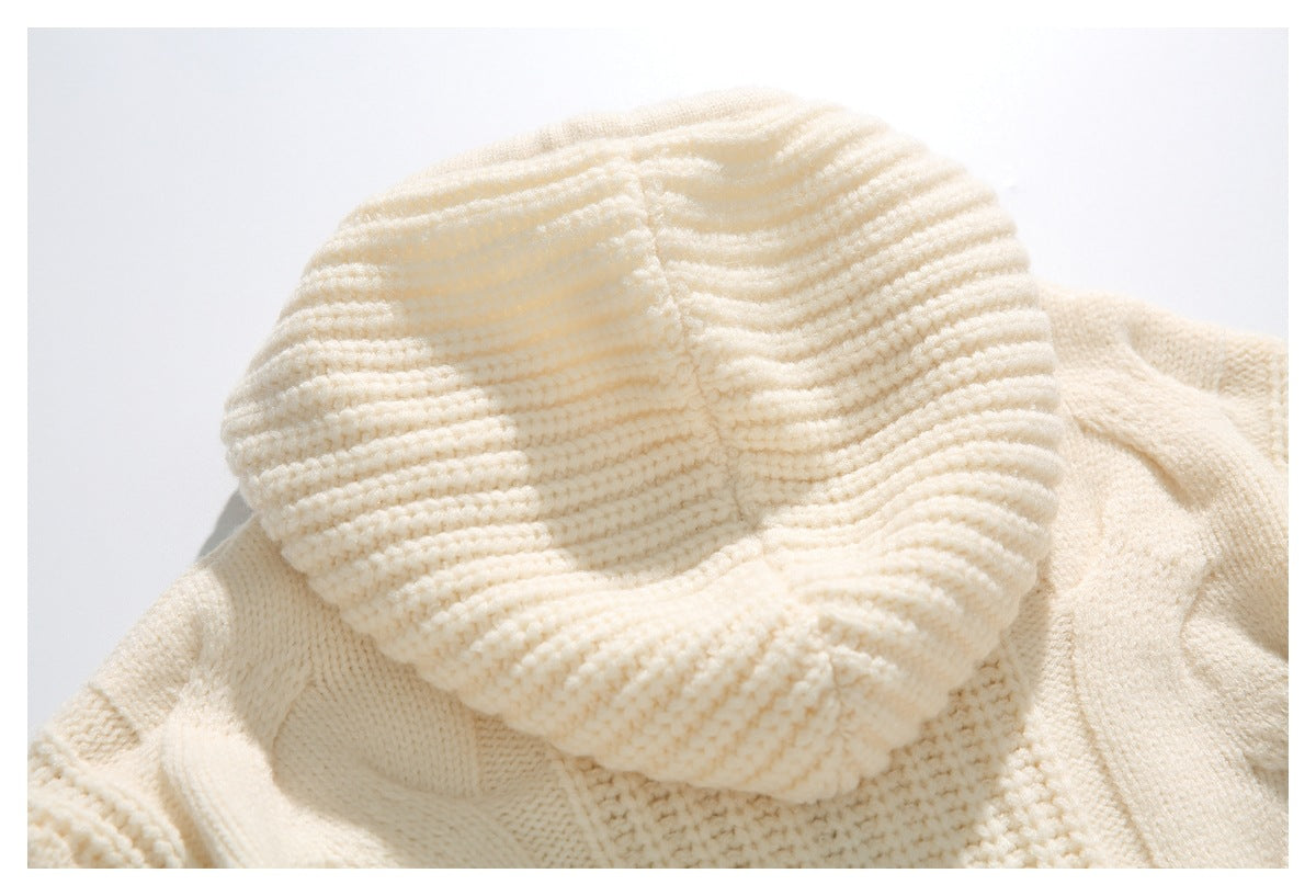 Close-up of a cream knitted sweater showing its thick, wavy ribbed collar.