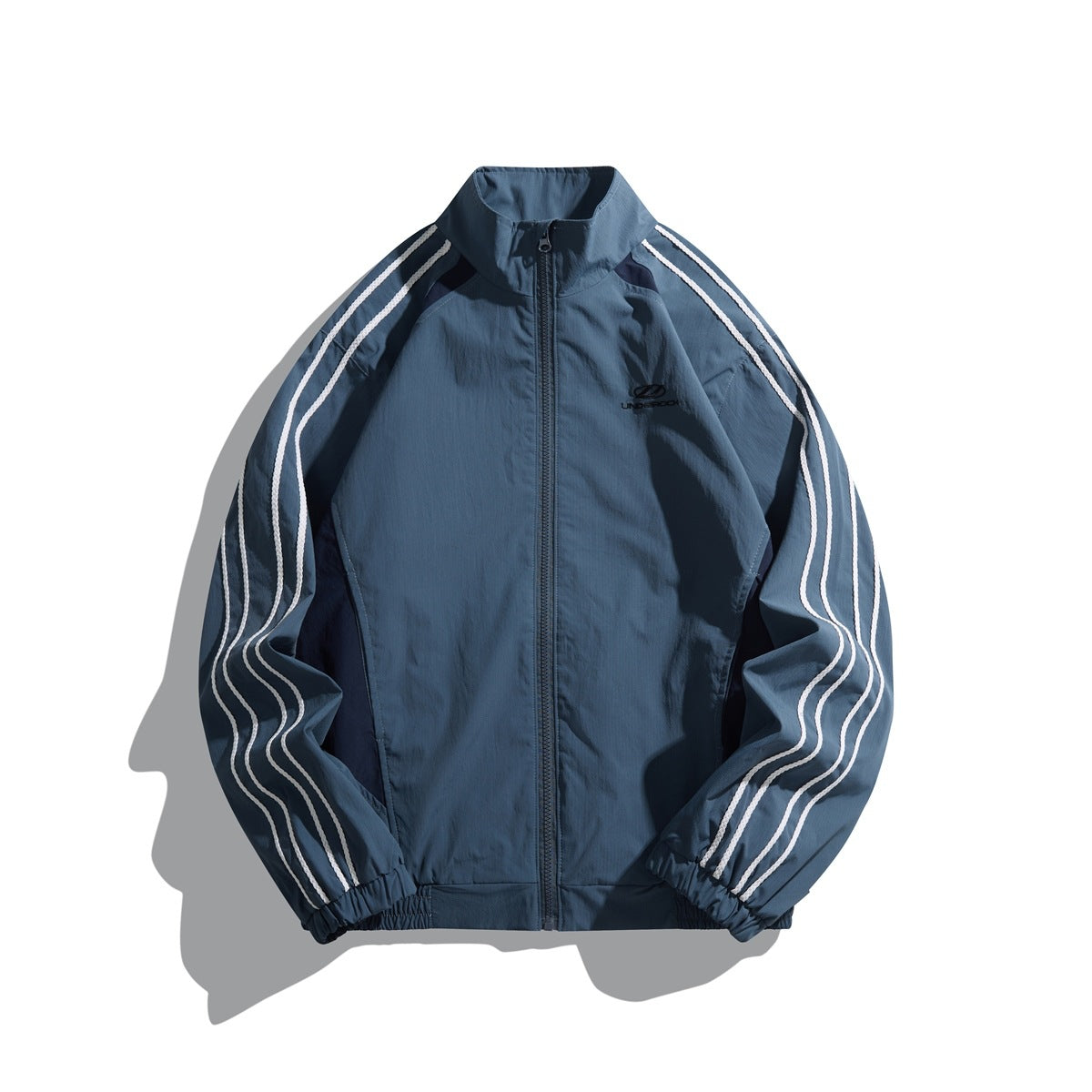Blue-gray stand-collar zip jacket with navy side panels and three white stripes on each sleeve, flat lay front view