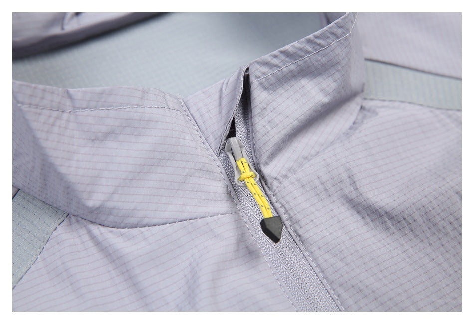 Close-up of a pale lavender jacket's stand collar and zipper with a yellow cord pull and black tip.