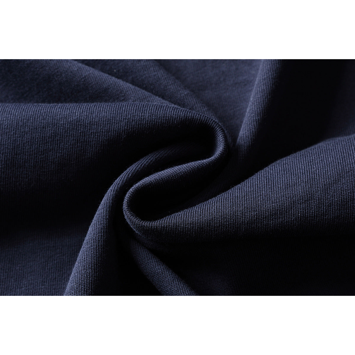 Close-up of navy fabric gathered into folds, showing its knit texture.