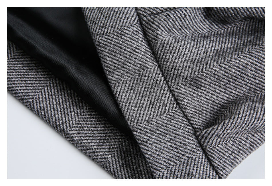 Close-up showing the black lining and gray herringbone fabric inside a jacket.