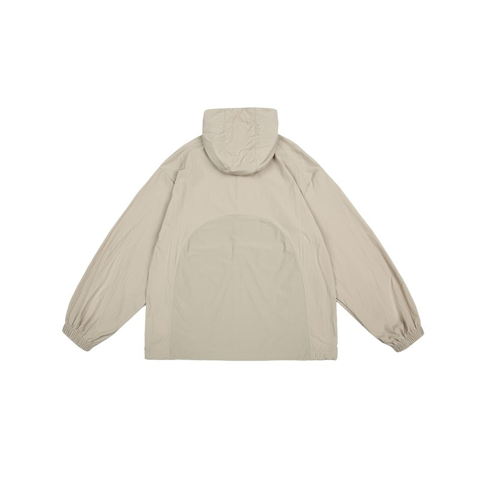 Back view of a beige hooded jacket with elastic cuffs and a large tone-on-tone arched back panel.
