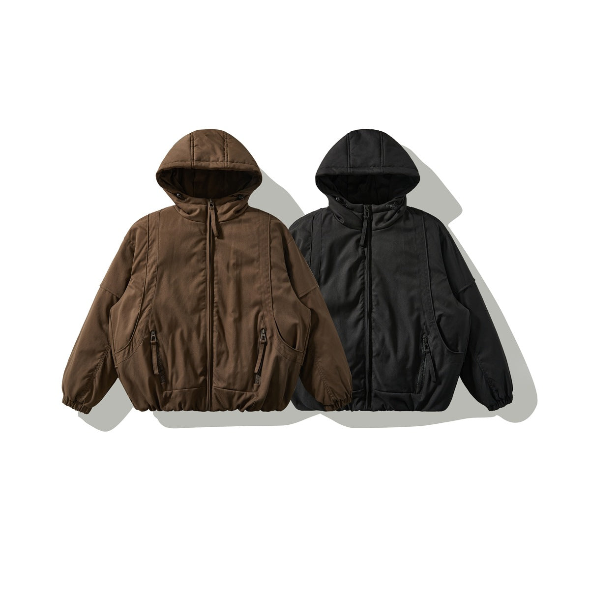Front view of hooded jackets in brown and black, with zip fronts and elasticated cuffs and hems.