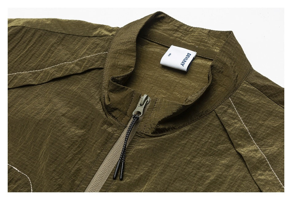 Olive jacket collar and upper front with a zipper, contrast stitching and a white neck label.