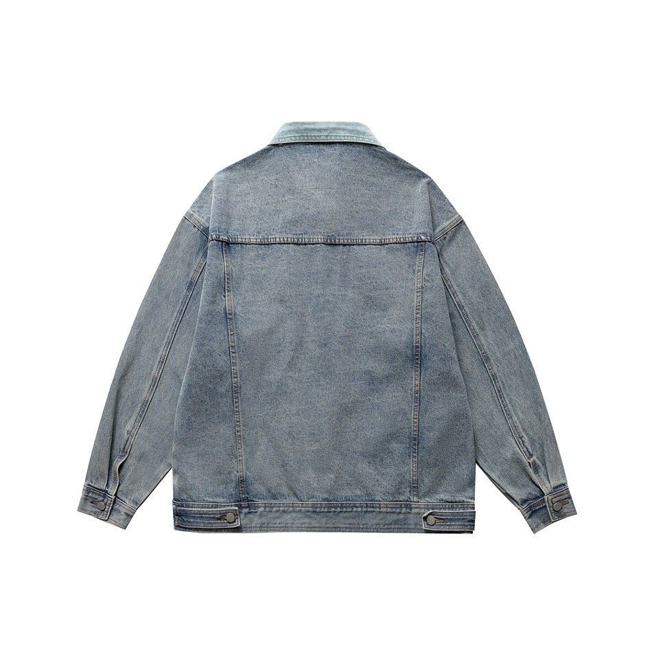 Back view of a blue washed denim jacket with yoke seam, button cuffs and waist button tabs