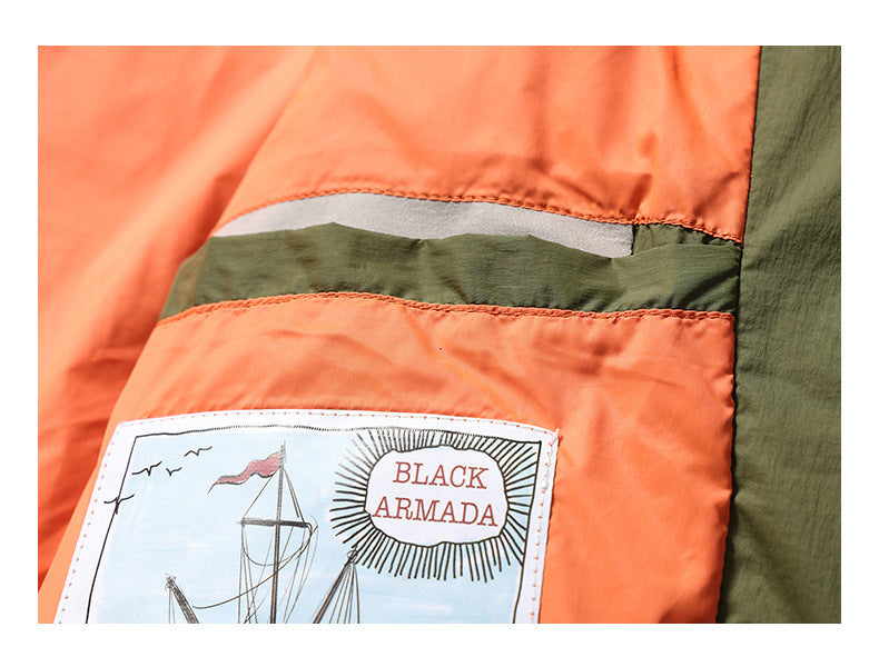 Close-up of the jacket's orange interior lining, reflective strip, and sewn-in BLACK ARMADA label.