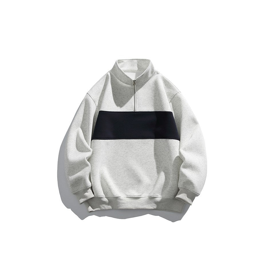 Light gray half-zip stand-collar sweatshirt with a navy chest panel, flat front view