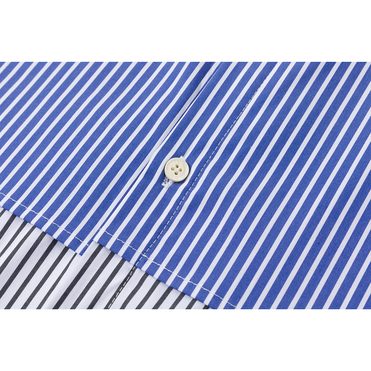 Close-up of blue-and-white striped shirt fabric, a white button, and the edge of contrasting black-and-white stripes.
