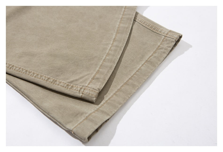 Close-up of the double-stitched hem on beige trousers.