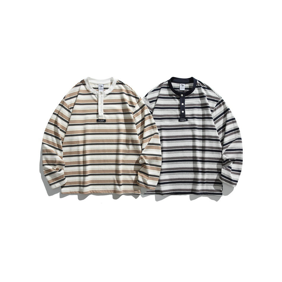 Two long-sleeve striped shirts shown from the front: one ivory with tan and black stripes, and one gray with black stripes.