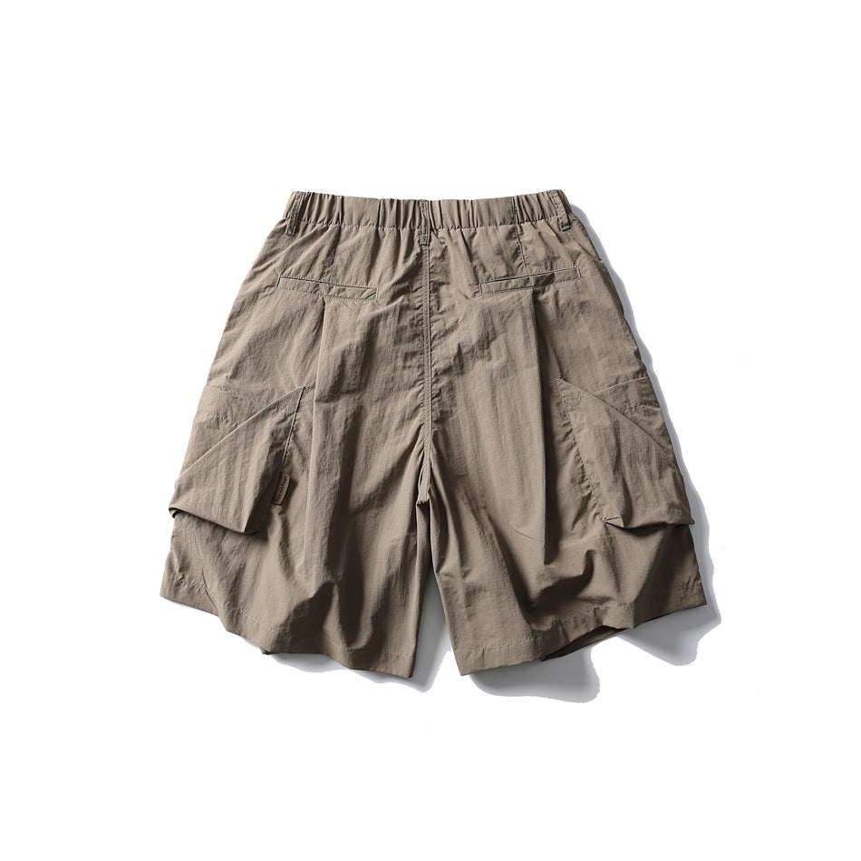 Taupe cargo shorts shown from the back, with an elastic waistband, two rear welt pockets and large side cargo pockets.