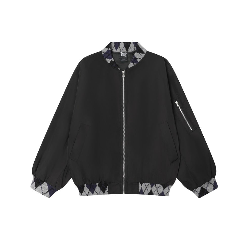 Front view of a black zip-front jacket with patterned knit collar, cuffs, and hem, plus angled pockets and a sleeve zipper