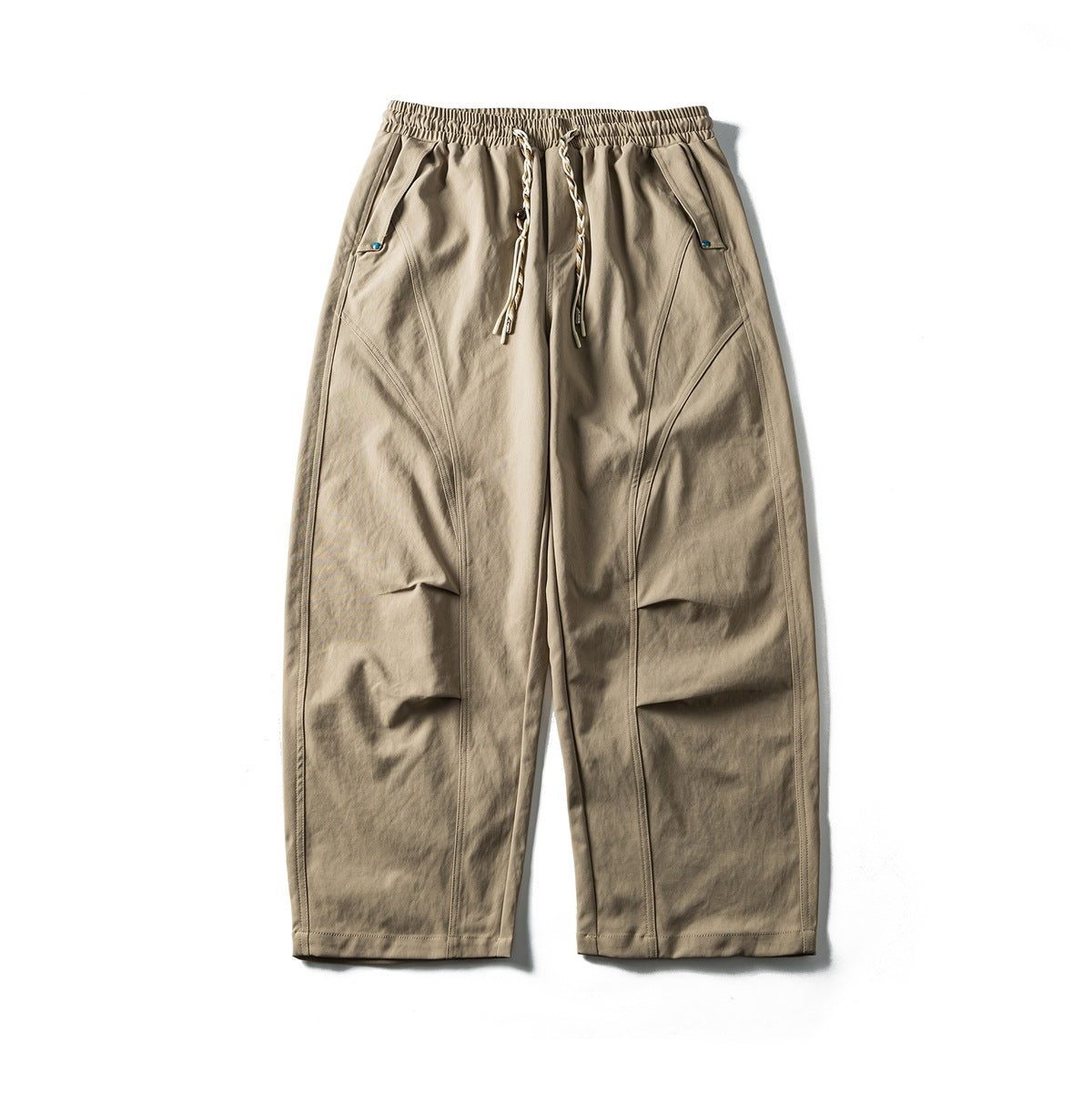 Khaki wide-leg pants flat lay with elastic drawstring waist, curved seams and knee pleats