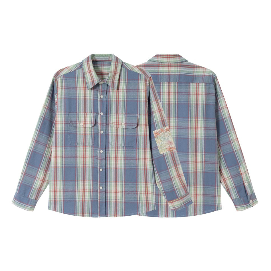 Blue plaid long-sleeve button-up shirt shown from the front and back, with two flap chest pockets and a floral sleeve patch.