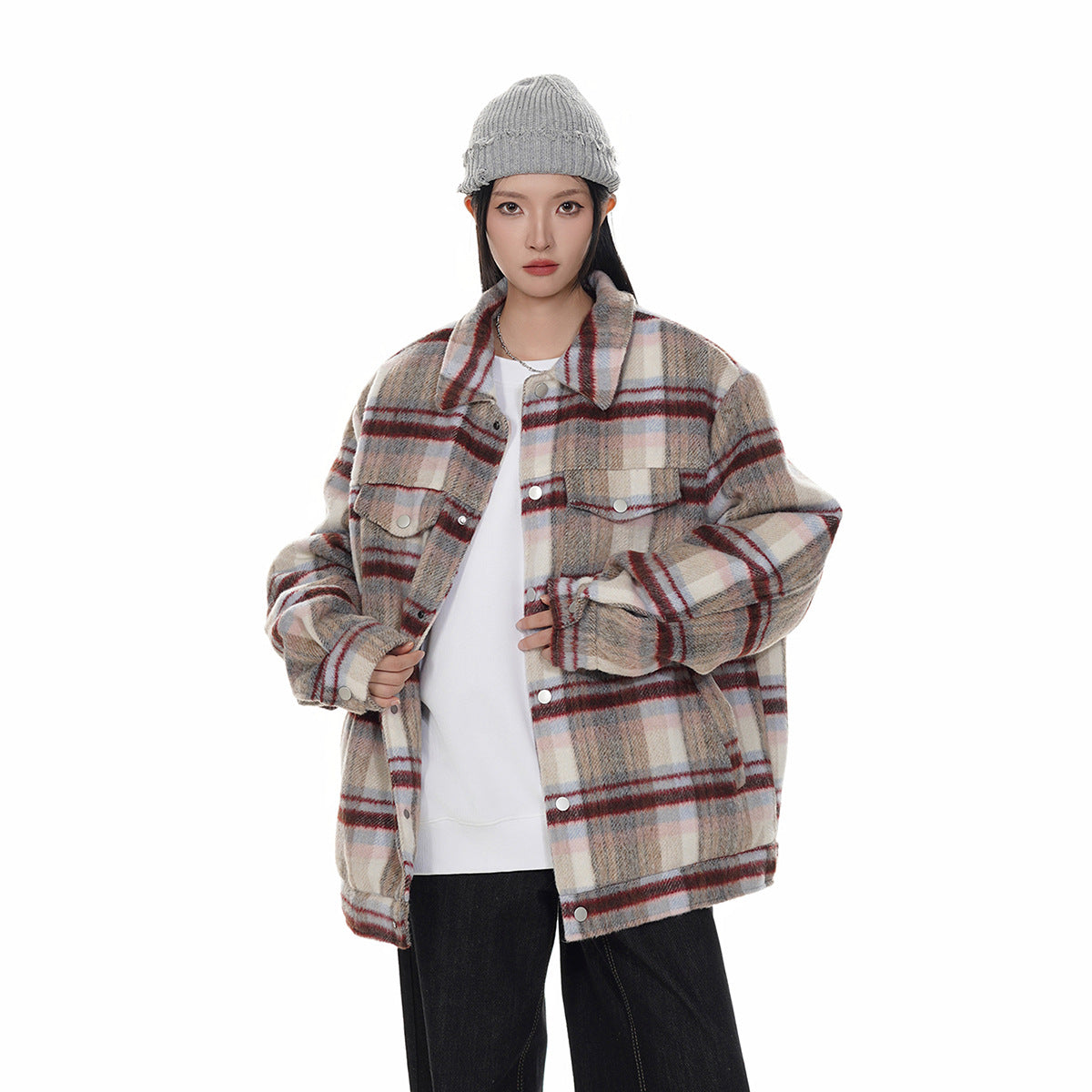Model wearing a cream, gray, and red plaid button-front jacket with chest pockets and a gray knit beanie.